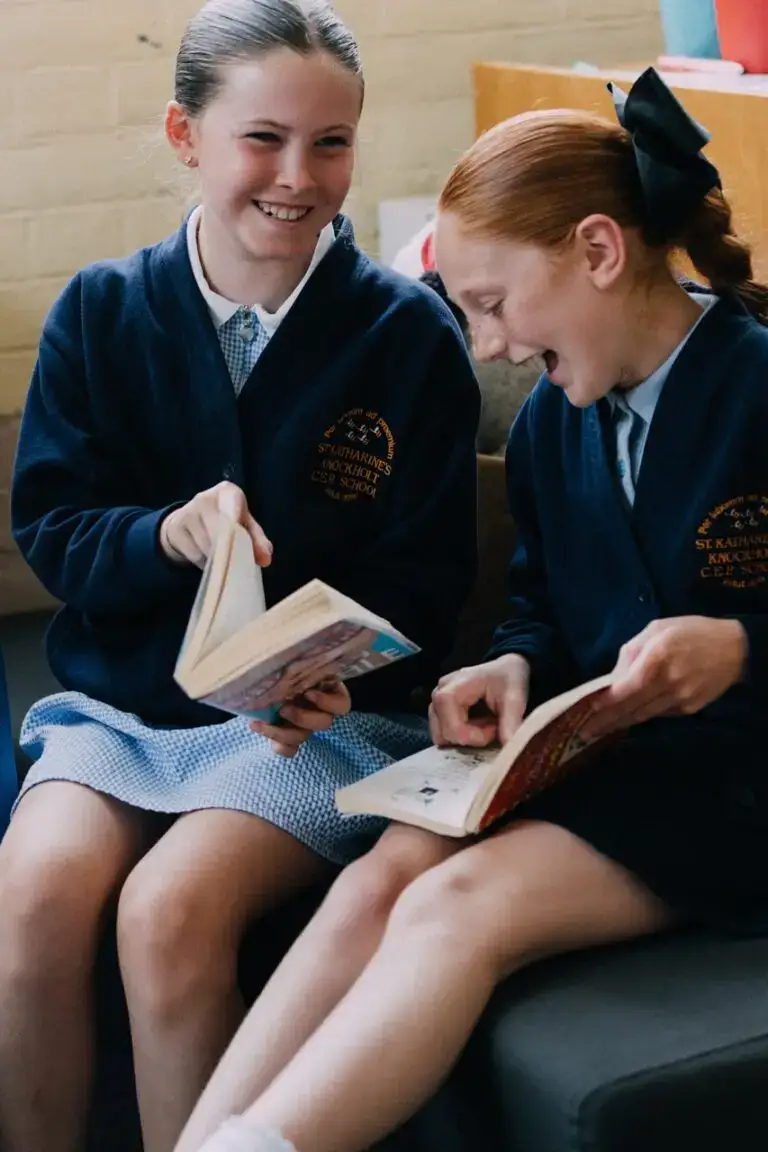 Children reading books at St Katharines Primary School, promoting literacy and early education in a supportive school environment.