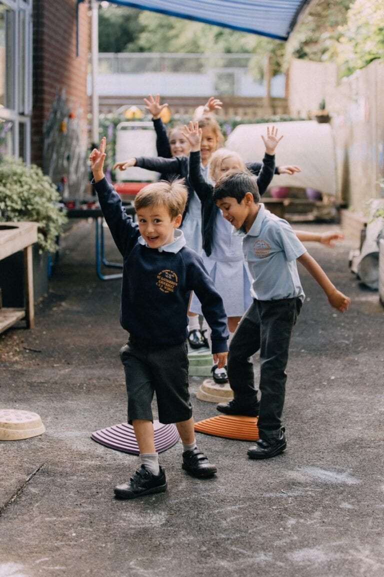 Children playing outside at St Katharines Primary School, outdoor learning activities, happy kids, playground, schoolyard, primary education, Kent, UK.